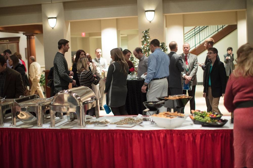 people gathering at the reception, a buffet table in the foreground